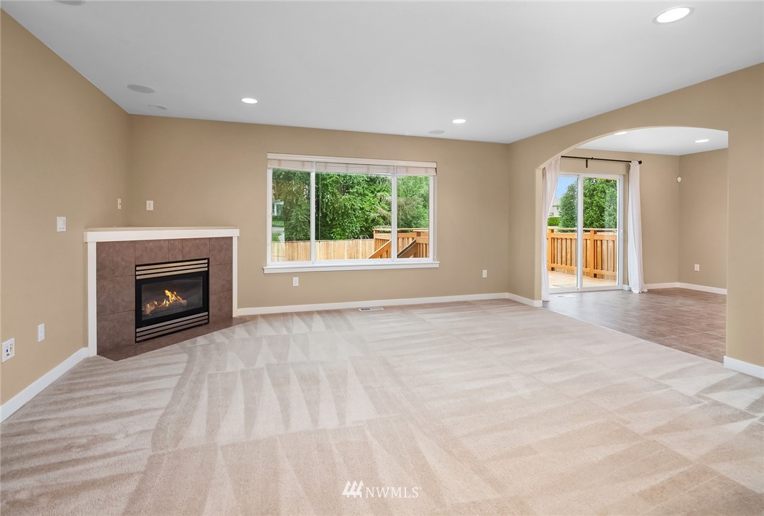 21006 42nd Avenue Southeast, Unit A Bothell, WA 98021 - Photo 4 of 19 a view of an empty room with a window and a fireplace