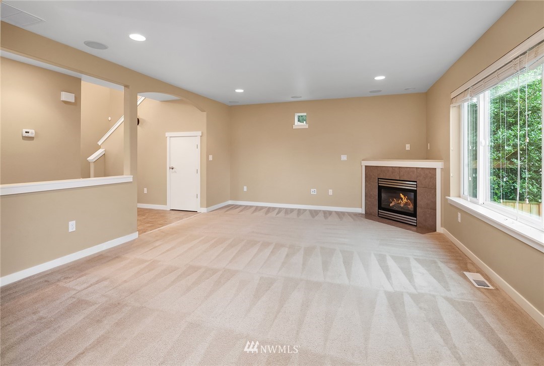 21006 42nd Avenue Southeast, Unit A Bothell, WA 98021 - Photo 5 of 19 a view of empty room with a fireplace and windows