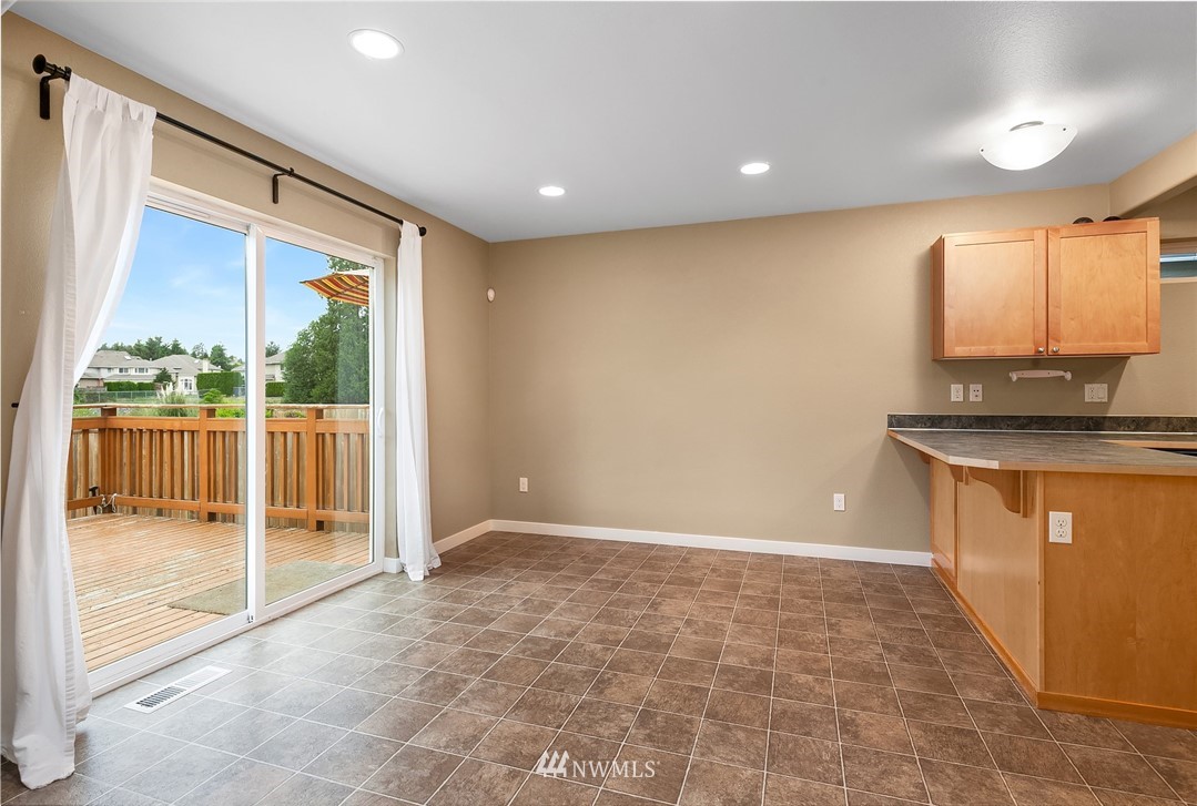 21006 42nd Avenue Southeast, Unit A Bothell, WA 98021 - Photo 6 of 19 a view of an empty room with a sliding door and wooden floor