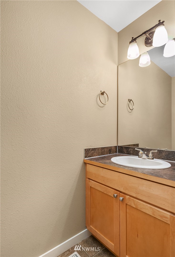 21006 42nd Avenue Southeast, Unit A Bothell, WA 98021 - Photo 10 of 19 a bathroom with a granite countertop sink and a mirror