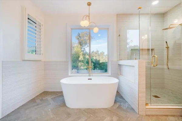 a white bath tub sitting next to a bathroom sink