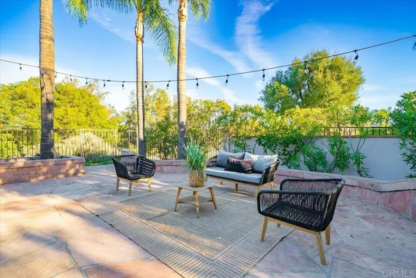 a view of a patio with table and chairs potted plants with wooden fence