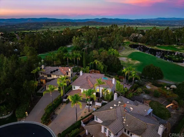 an aerial view of a houses with a yard