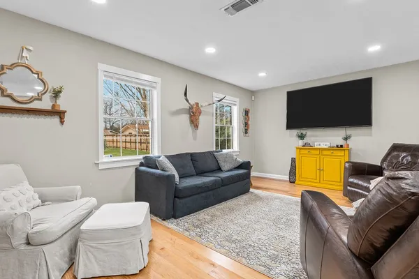 a living room with furniture and a flat screen tv