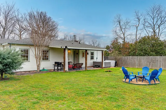 a view of a house with backyard porch and furniture