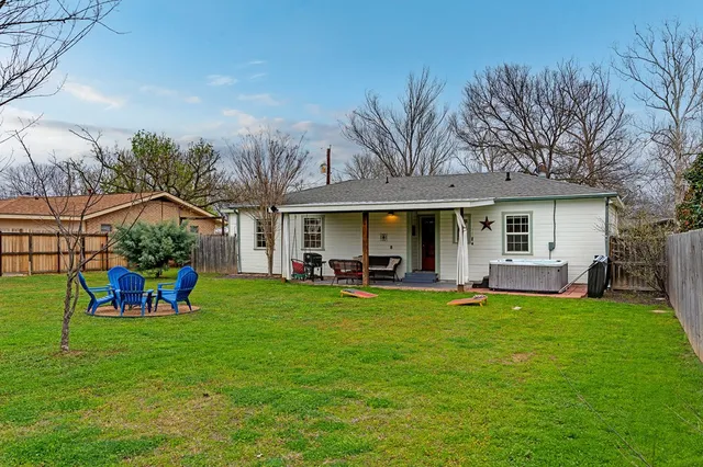 a view of a house with a yard porch and sitting area