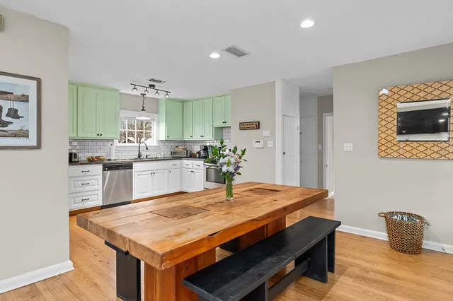 a kitchen with kitchen island a stove and a refrigerator