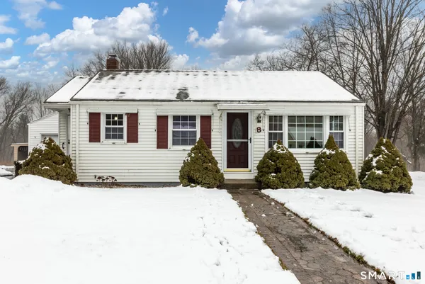 a view of a house with snow in the background