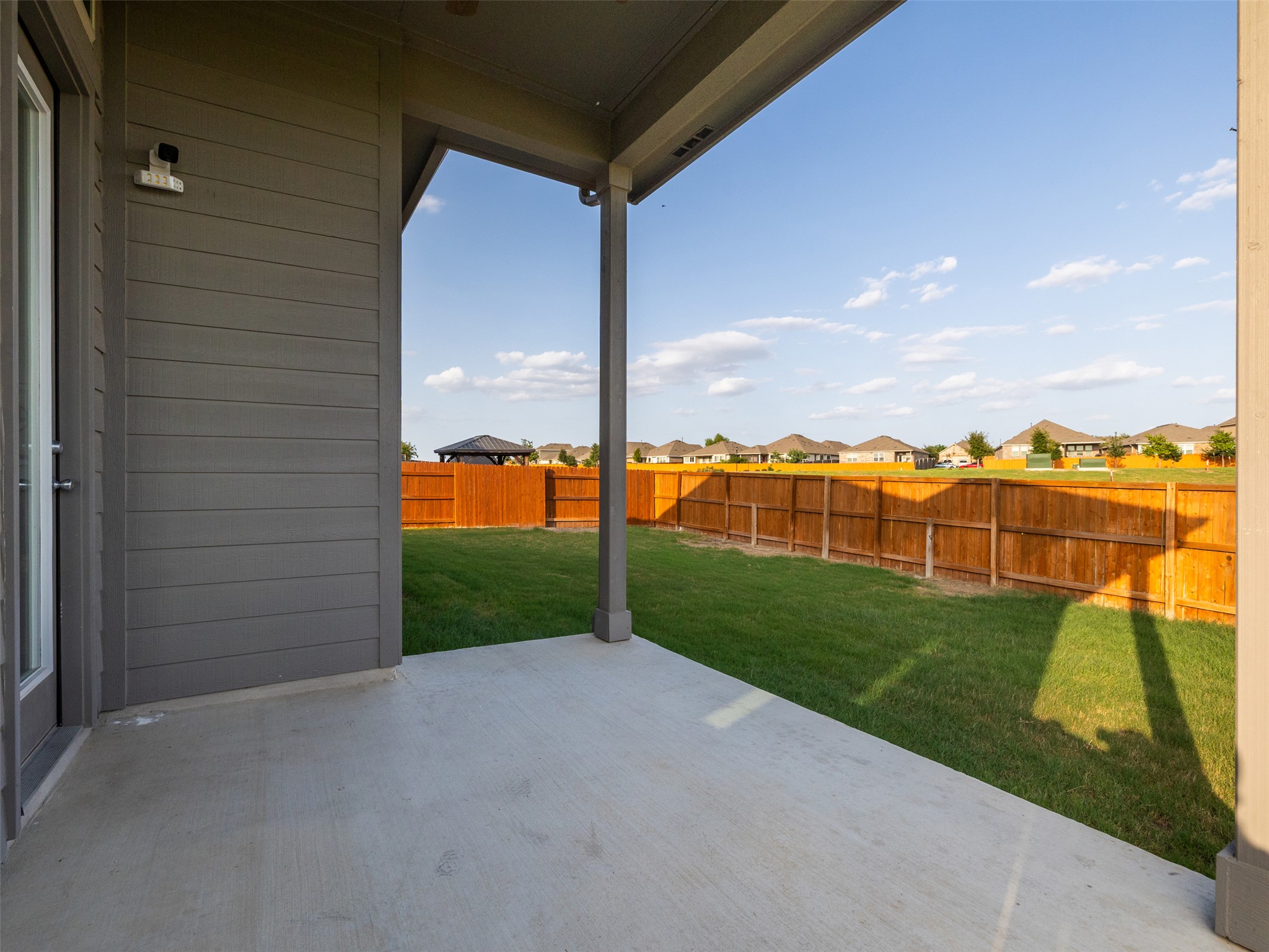 606 Spinnaker Loop Kyle, TX 78640 - Photo 22 of 37 A generously sized covered patio offers an ideal space for outdoor enjoyment and relaxation.
