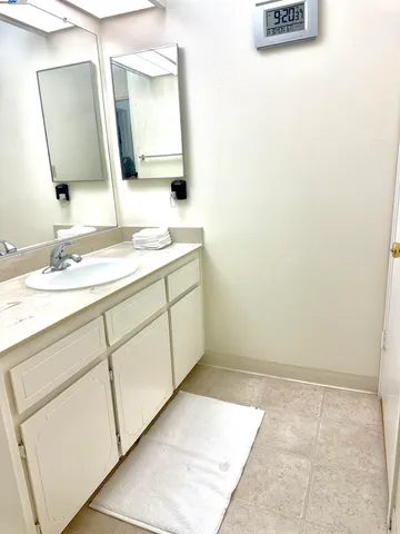 a bathroom with a sink vanity and mirror
