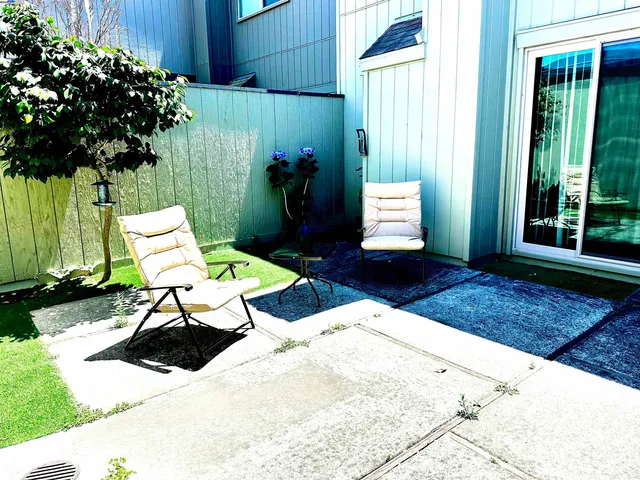 a wooden bench sitting in front of a building