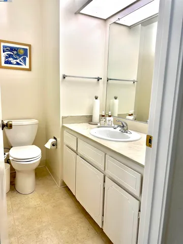 a bathroom with a toilet sink and a mirror