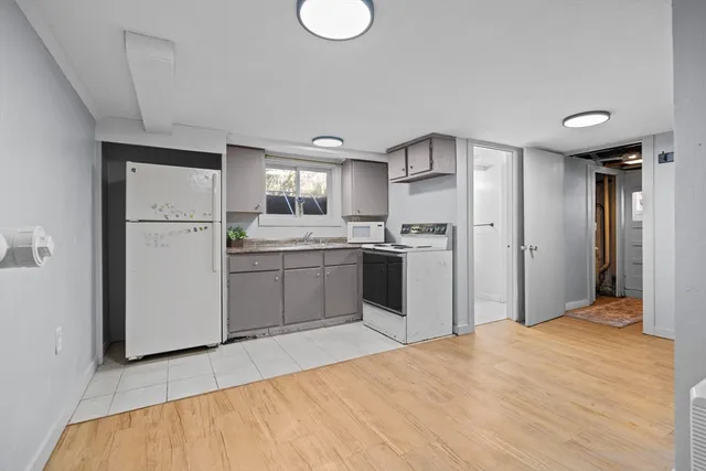a kitchen with stainless steel appliances a refrigerator sink and cabinets