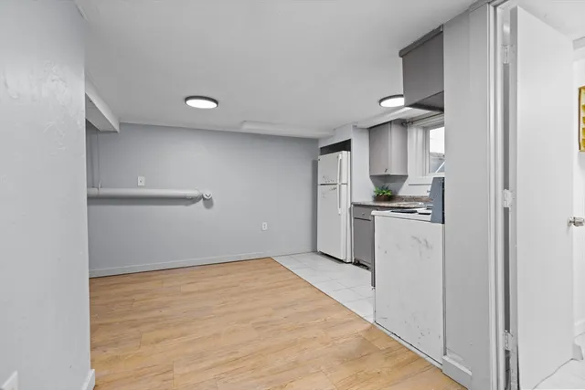 a kitchen with white cabinets and white appliances