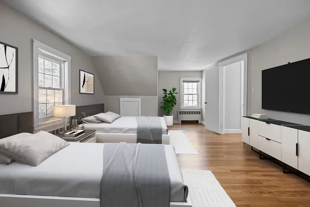 a bedroom with furniture and a flat screen tv