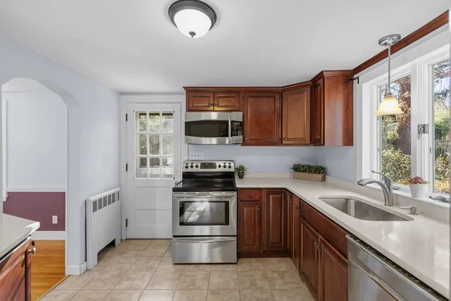 a kitchen with a sink stove top oven and refrigerator
