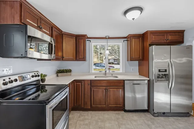 a kitchen with a stove sink and refrigerator