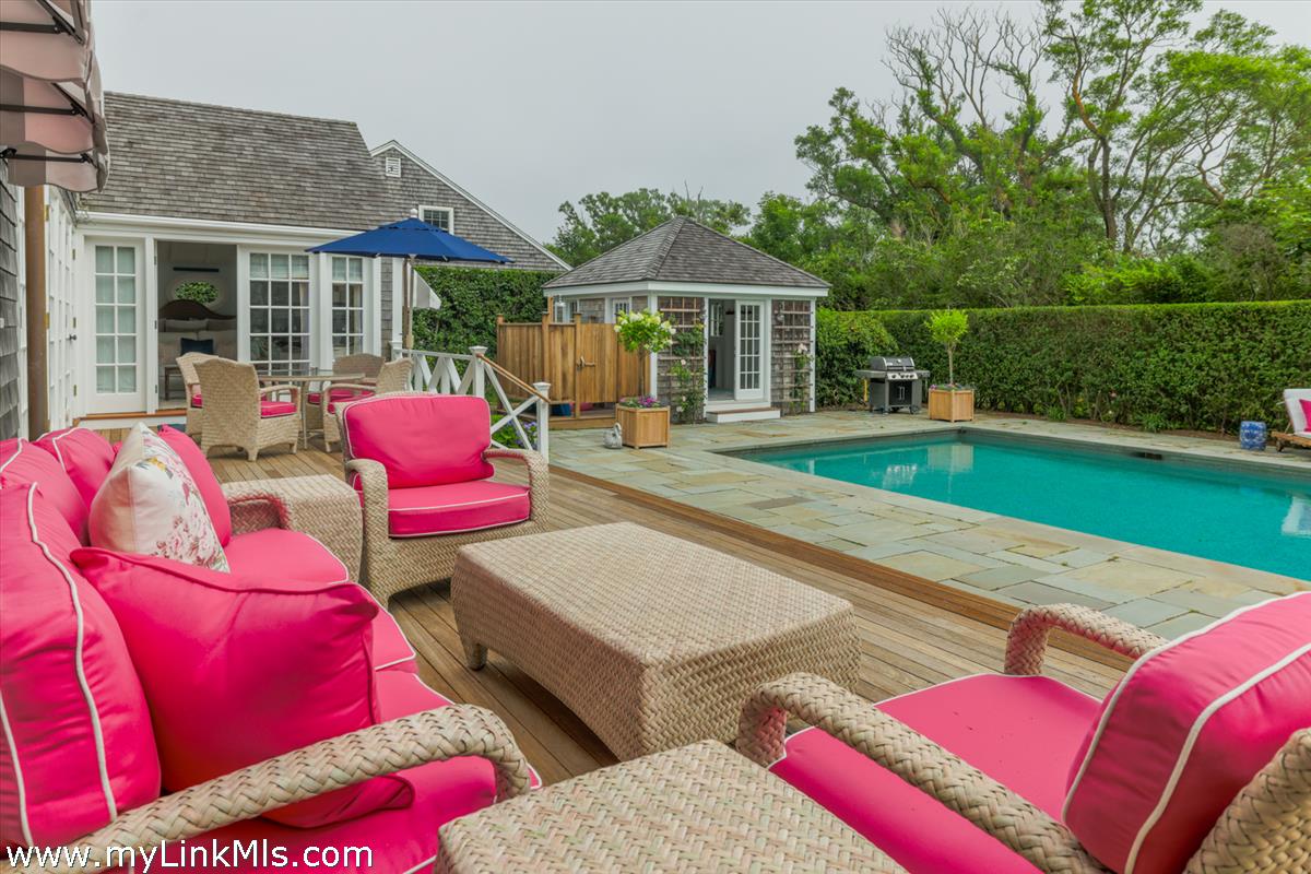 14 & 16 Coffin Street Nantucket, MA 02554 - Photo 22 of 50 a view of a patio with couches table and chairs with wooden floor and fence