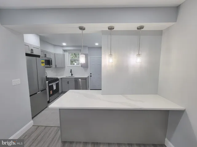 a view of kitchen and refrigerator