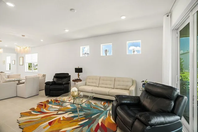 a living room with furniture and a chandelier