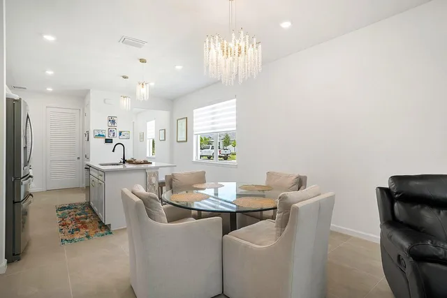 a kitchen with a sink a counter space and living room