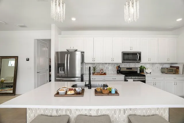 a kitchen with sink refrigerator and microwave