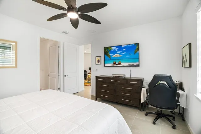 a living room with furniture a window and a flat screen tv