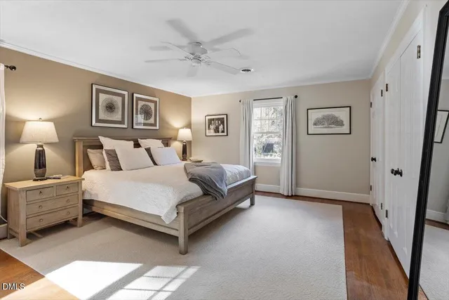 a spacious bedroom with a bed and a painting on the wall
