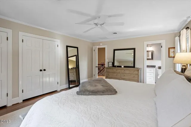 a large bedroom with a bed and a large mirror