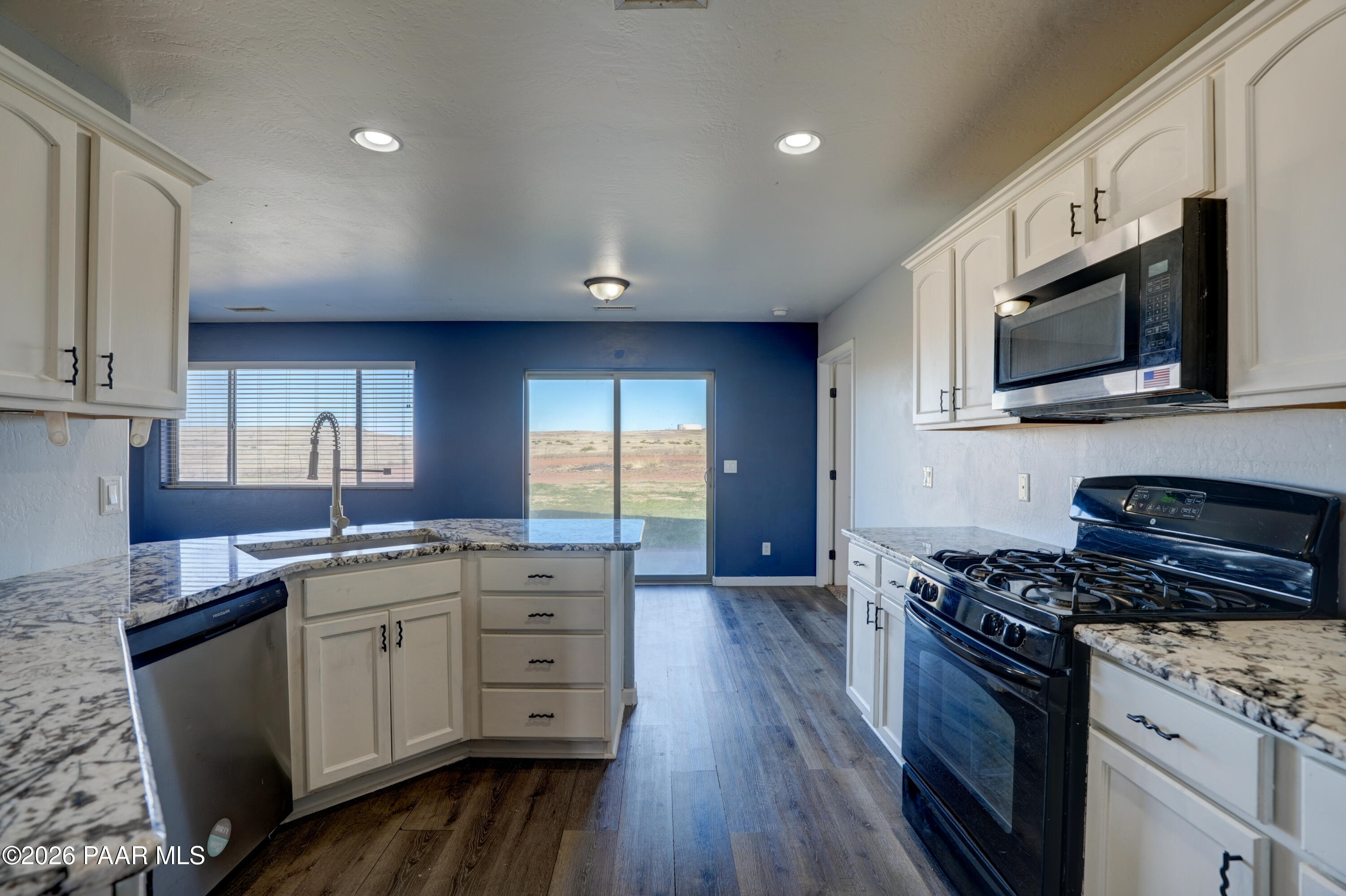 200 North Outback Road Dewey, AZ 86327 - Photo 4 of 34 a kitchen with stainless steel appliances a sink cabinets and wooden floor