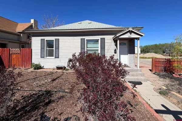 a front view of house with yard and car parked