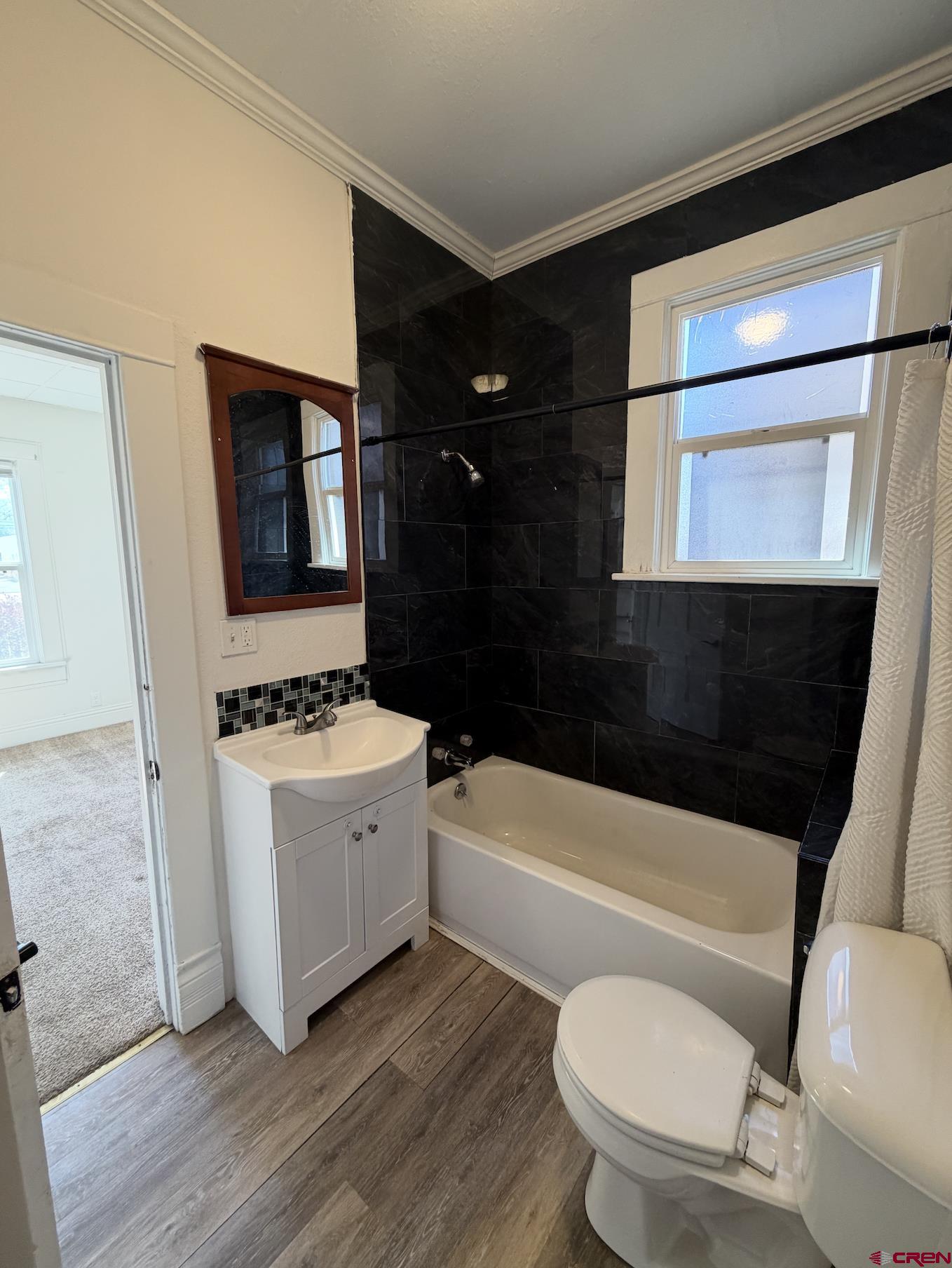 1001 Main Street Delta, CO 81416 - Photo 11 of 29 a bathroom with a toilet a sink and bathtub