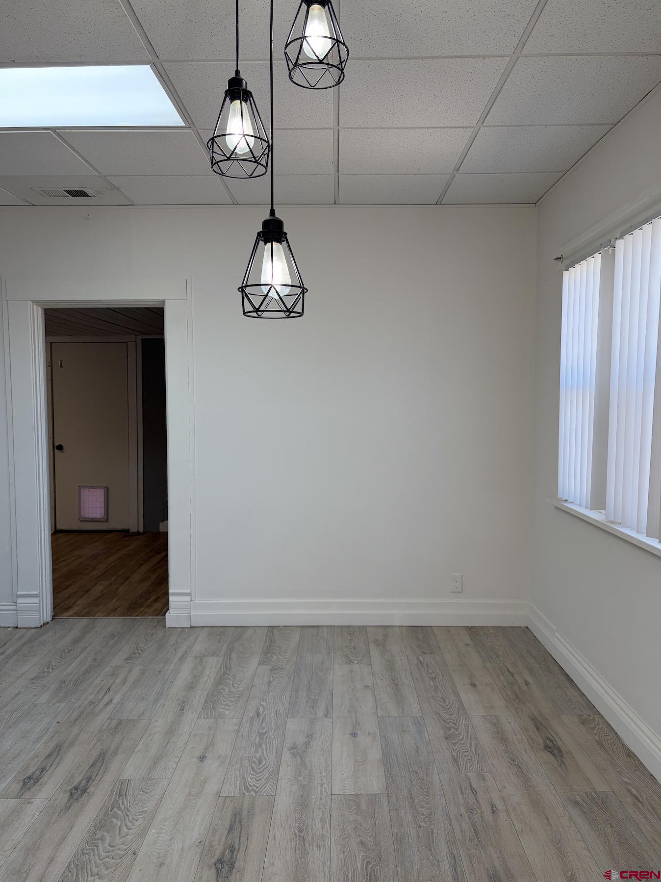 1001 Main Street Delta, CO 81416 - Photo 14 of 29 a view of empty room with wooden floor and window