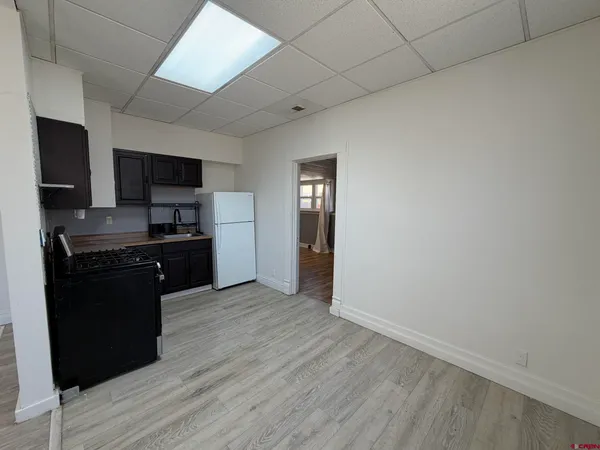 a kitchen with granite countertop a refrigerator stove and microwave