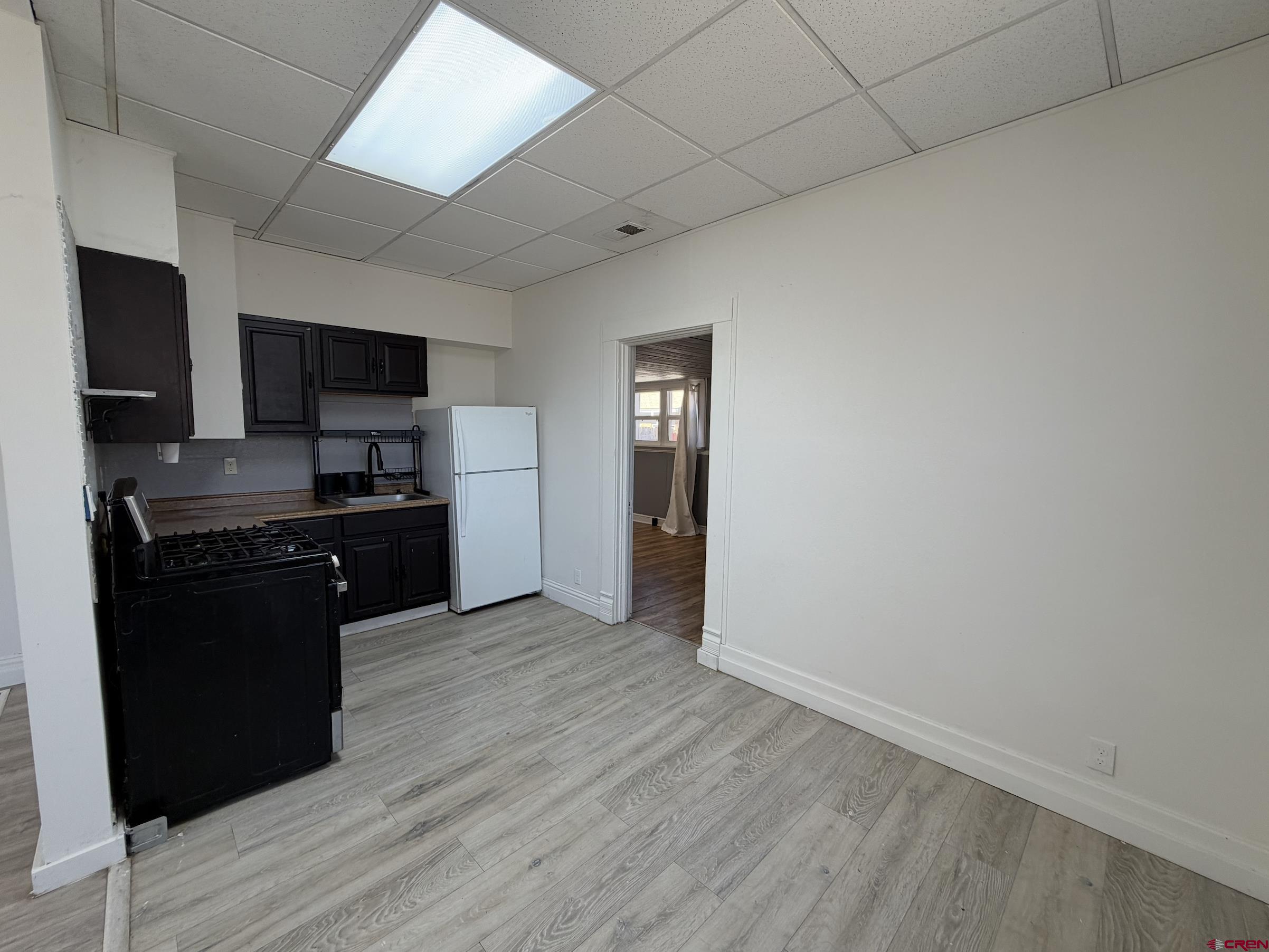 1001 Main Street Delta, CO 81416 - Photo 15 of 29 a kitchen with granite countertop a refrigerator stove and microwave