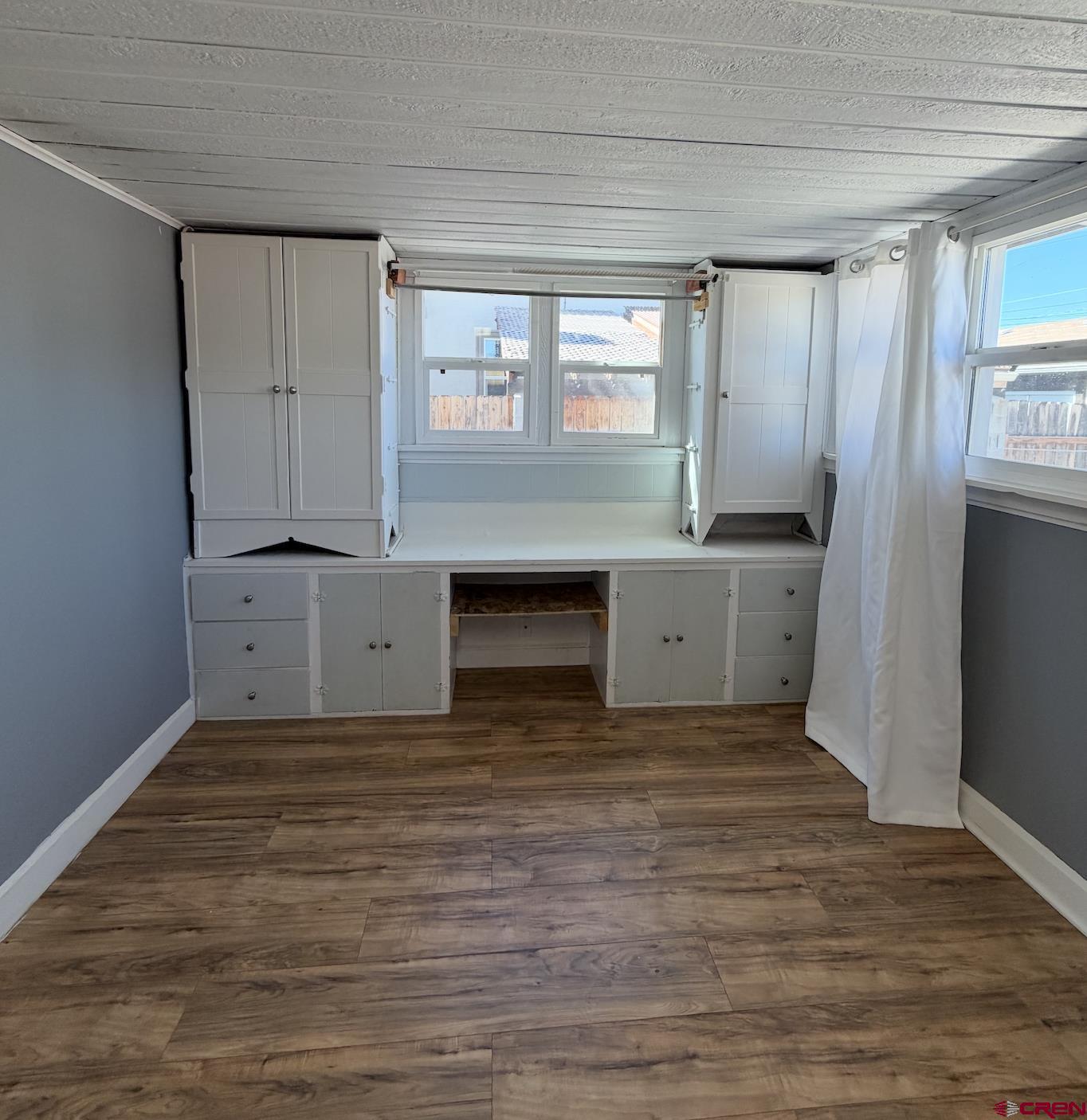 1001 Main Street Delta, CO 81416 - Photo 18 of 29 a view of kitchen with granite countertop cabinets and wooden floor