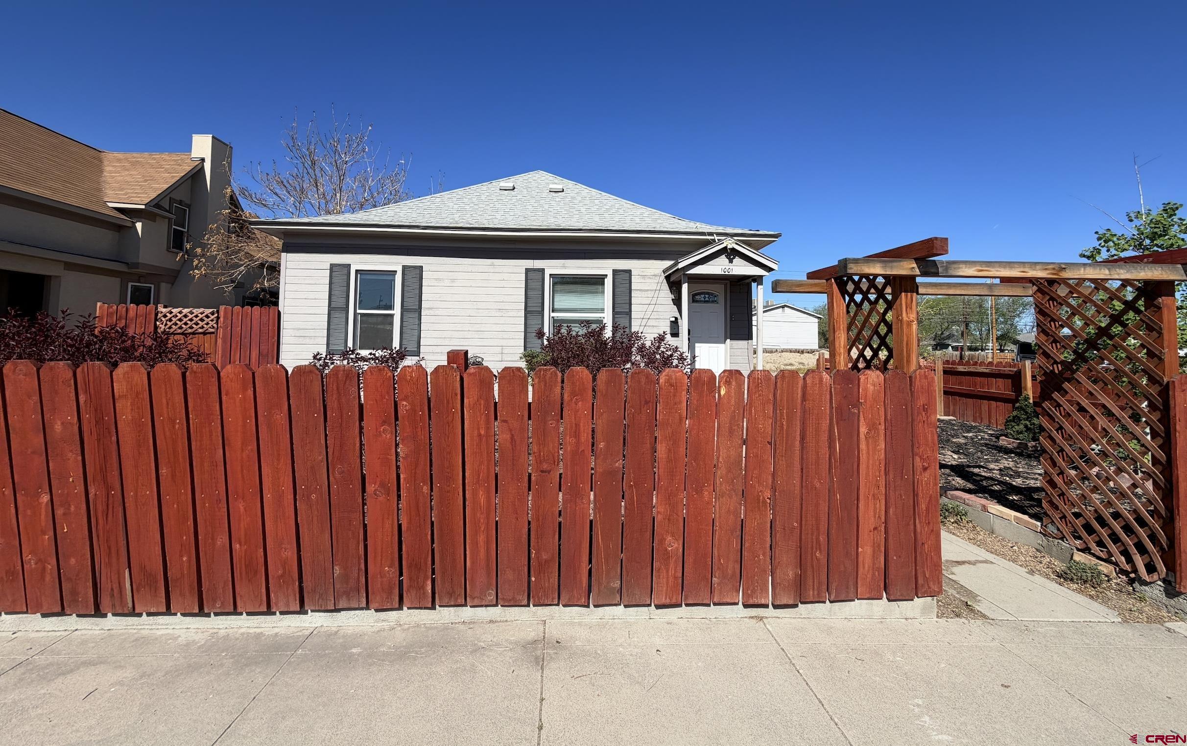 1001 Main Street Delta, CO 81416 - Photo 2 of 29 a front view of a house with a garden