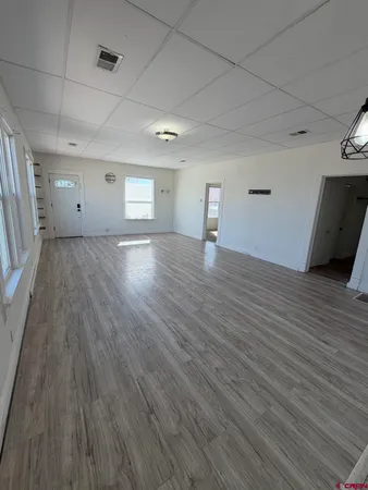 a view of an empty room and wooden floor