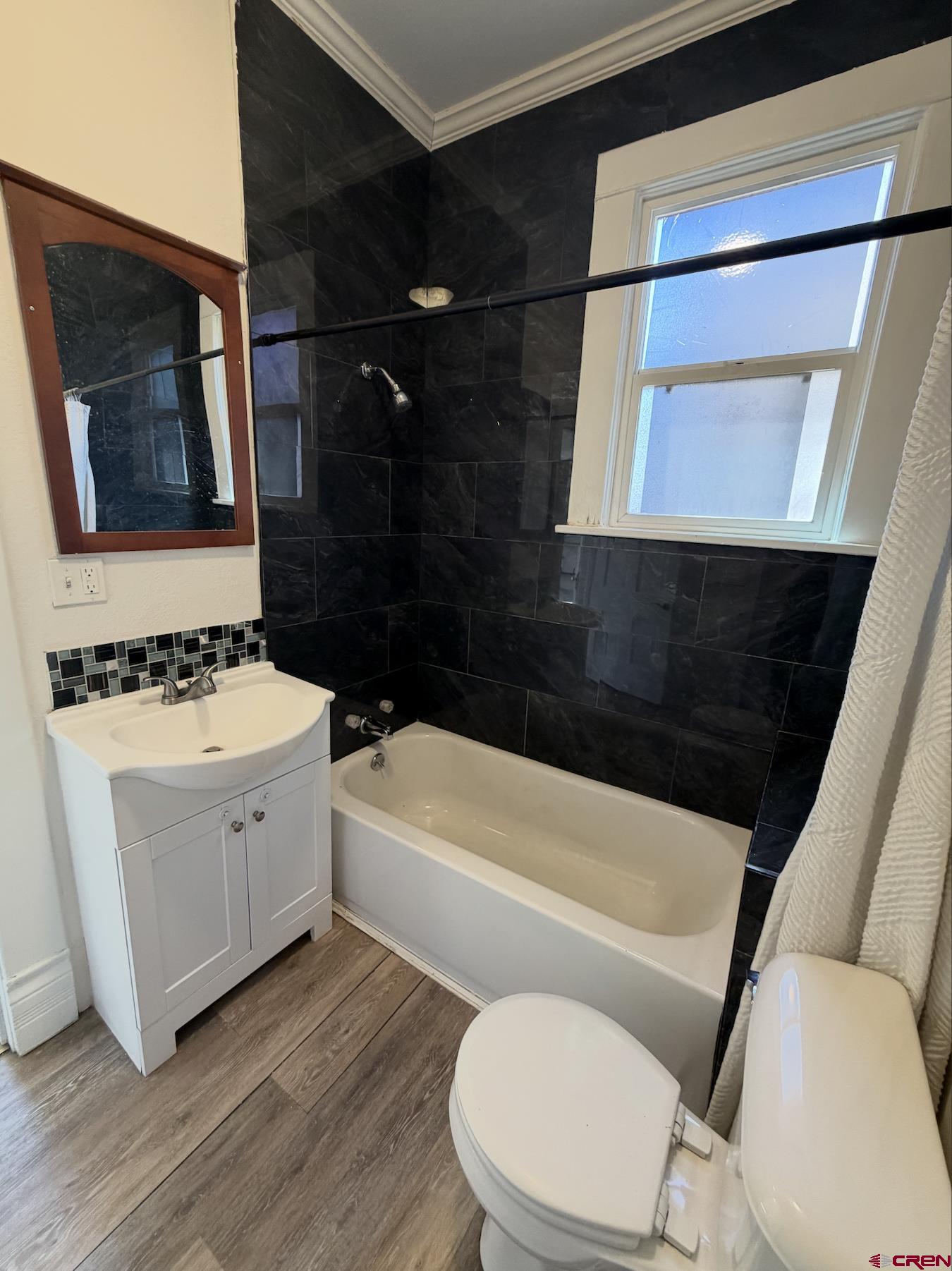 1001 Main Street Delta, CO 81416 - Photo 9 of 29 a bathroom with a toilet a sink and bathtub
