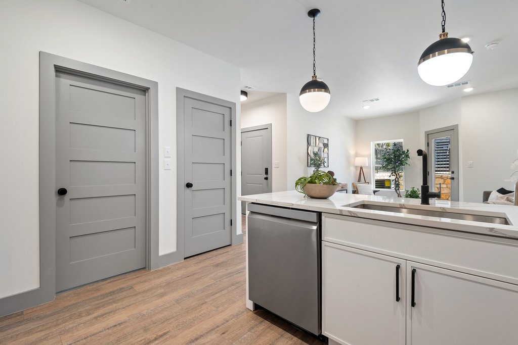 2450 Wickersham Lane, Unit 1927 Austin, TX 78741 - Photo 12 of 40 a kitchen with cabinets and wooden floor