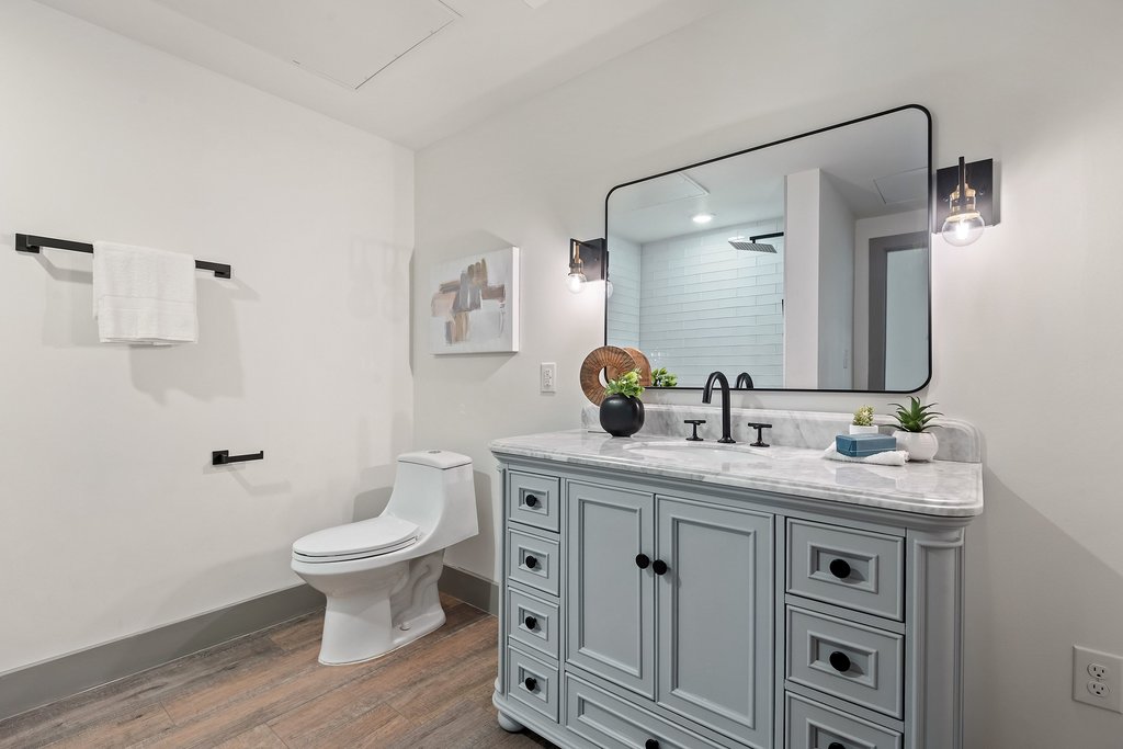 2450 Wickersham Lane, Unit 1927 Austin, TX 78741 - Photo 19 of 40 a bathroom with a sink toilet a mirror and vanity