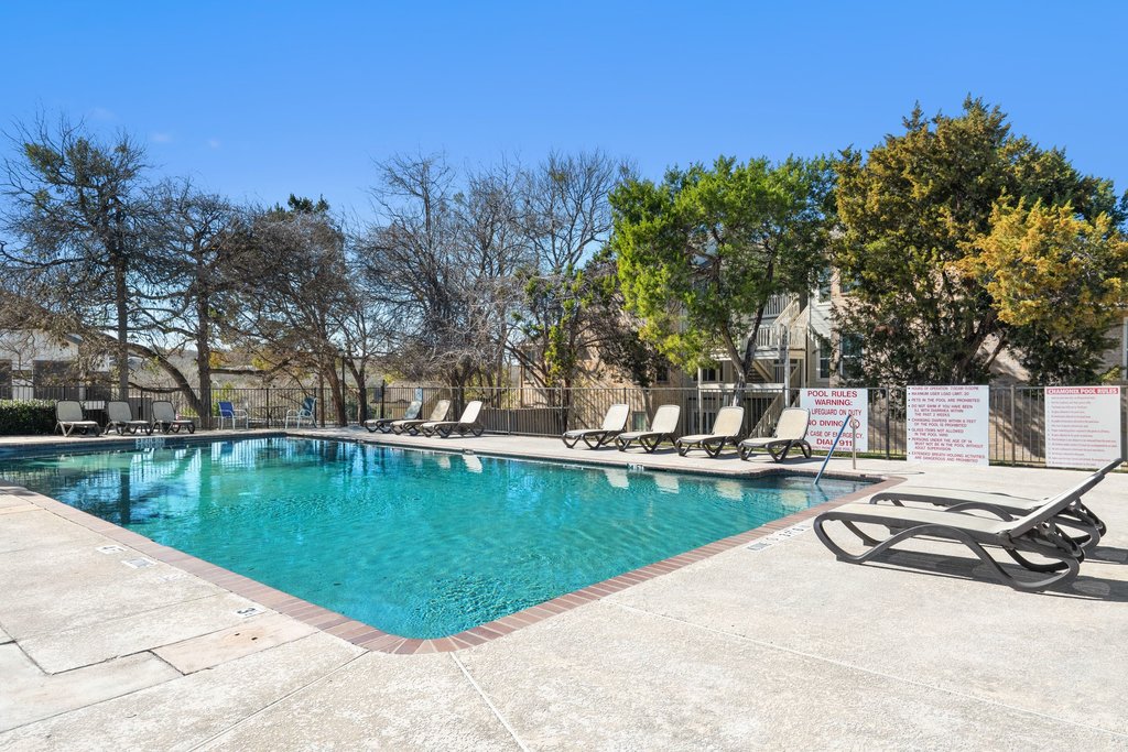 2450 Wickersham Lane, Unit 1927 Austin, TX 78741 - Photo 27 of 40 a view of a swimming pool with a patio and a yard