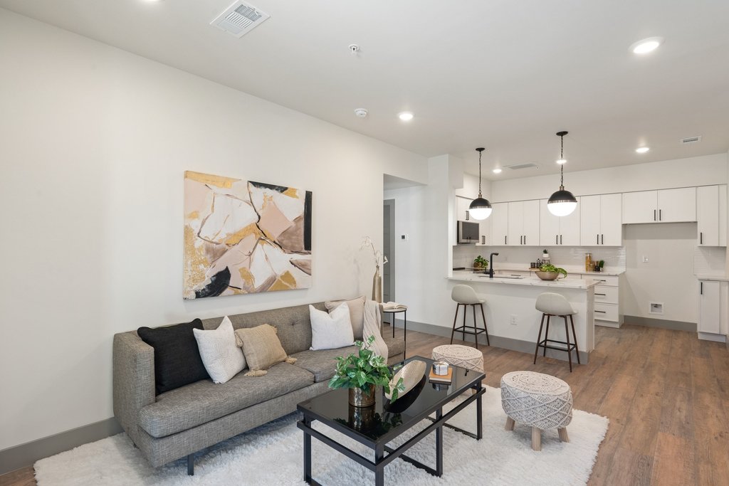 2450 Wickersham Lane, Unit 1927 Austin, TX 78741 - Photo 6 of 40 a living room with stainless steel appliances kitchen island a table and a couch