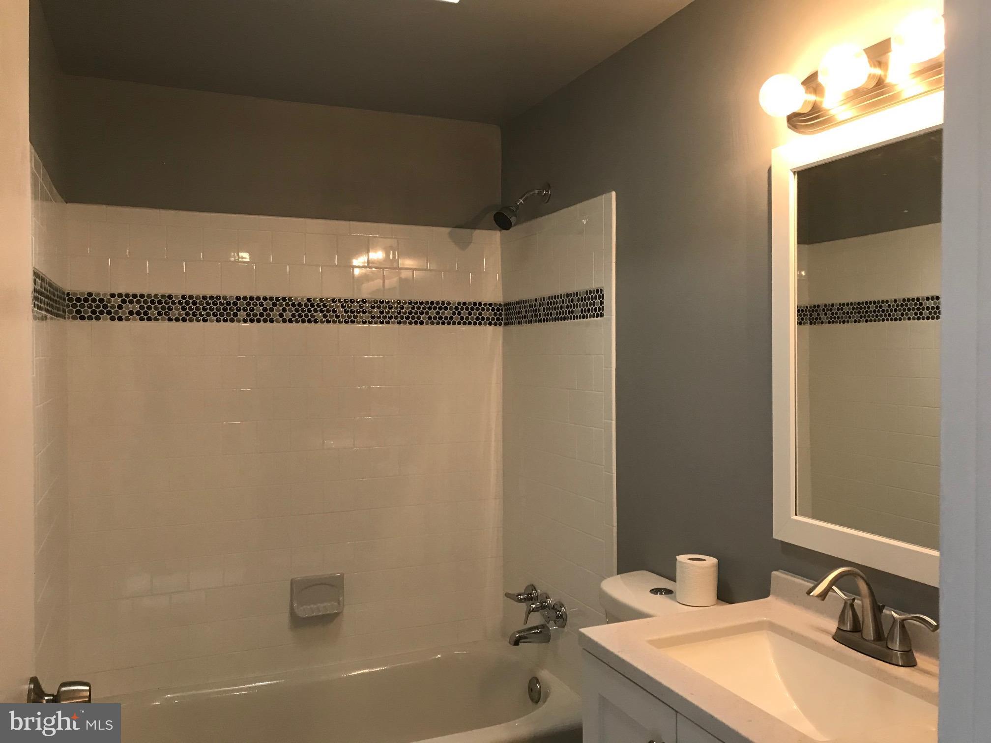 7950 Wynbrook Road Baltimore, MD 21224 - Photo 13 of 22 Ceramic tile tub surround with accent tile