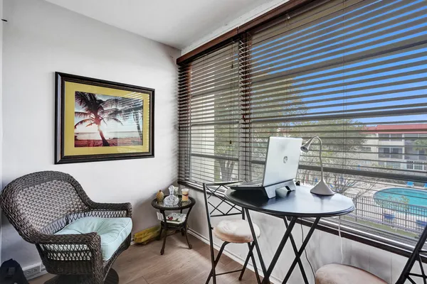 a view of a workspace with furniture and window