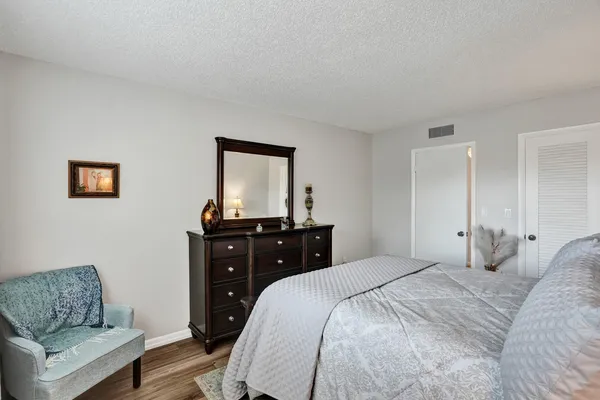 a bedroom with a bed and a couch