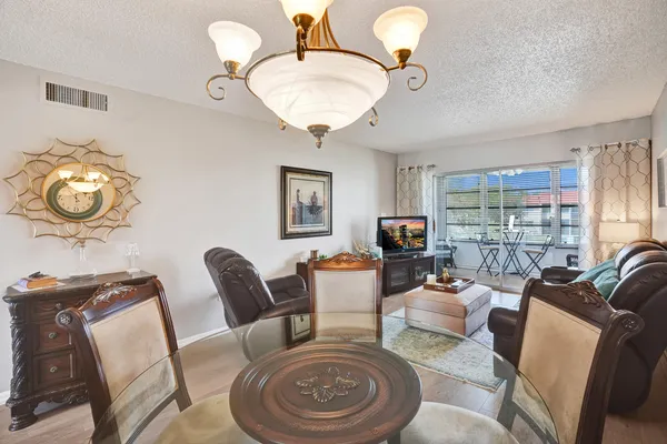 a living room with furniture a fireplace and a large window