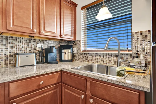 a kitchen with granite countertop a sink and a window