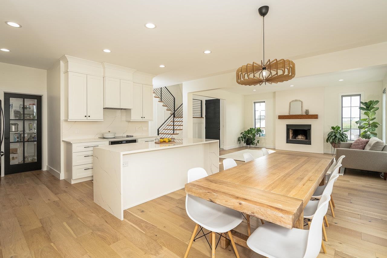 130 Millview Drive Bridgewater, VA 22812 - Photo 52 of 74 a kitchen with stainless steel appliances kitchen island granite countertop a stove a refrigerator a oven a white dining table and chairs with wooden floor