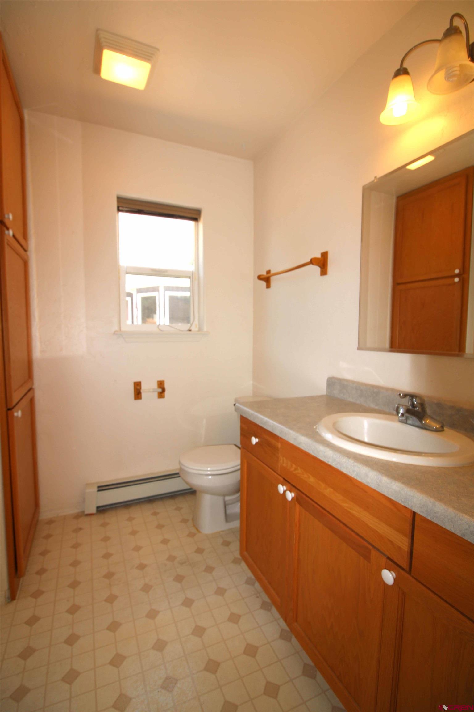 185-165 Northwest 11th Street Cedaredge, CO 81413 - Photo 18 of 34 a bathroom with a sink a toilet and mirror